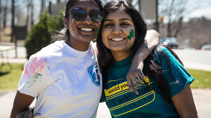 Two Bentley students covered in colors during Festival of Colors Holi event