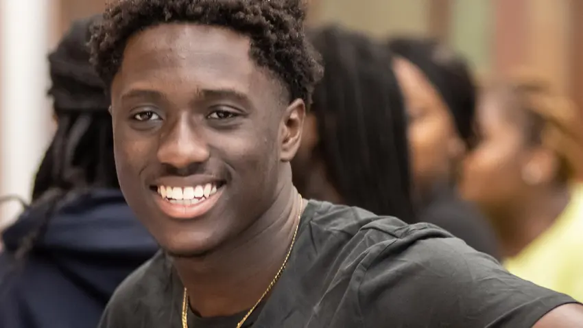 student smiles while attending event