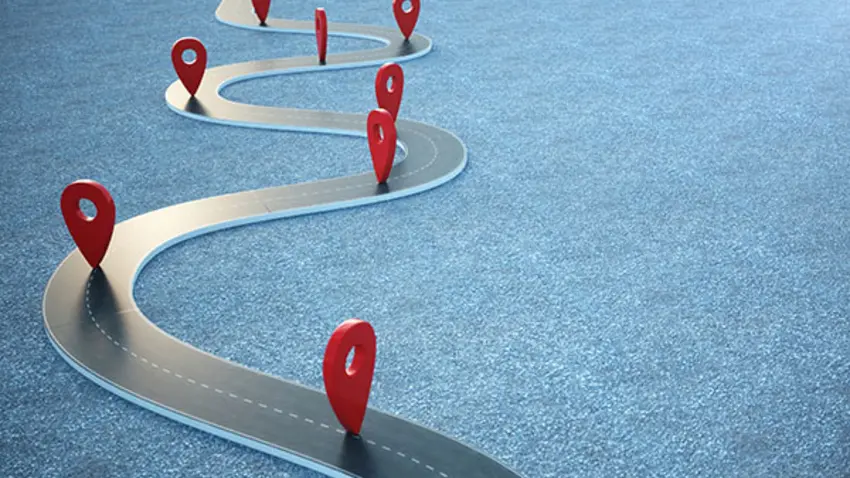 Winding road showing stops along the way which represent career changes and interruptions
