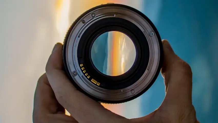 Camera lens with beachscape in background