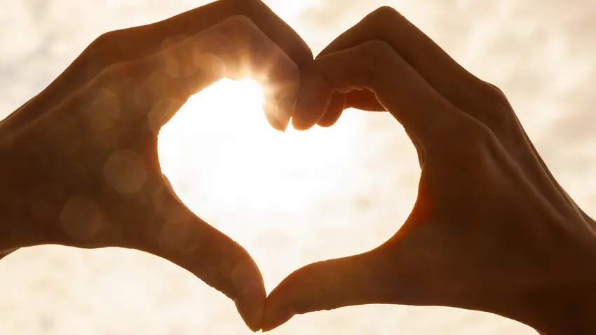 Hand making a heart shape