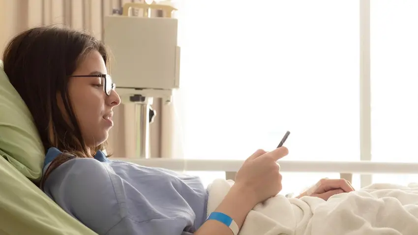 Student on a phone in a hospital