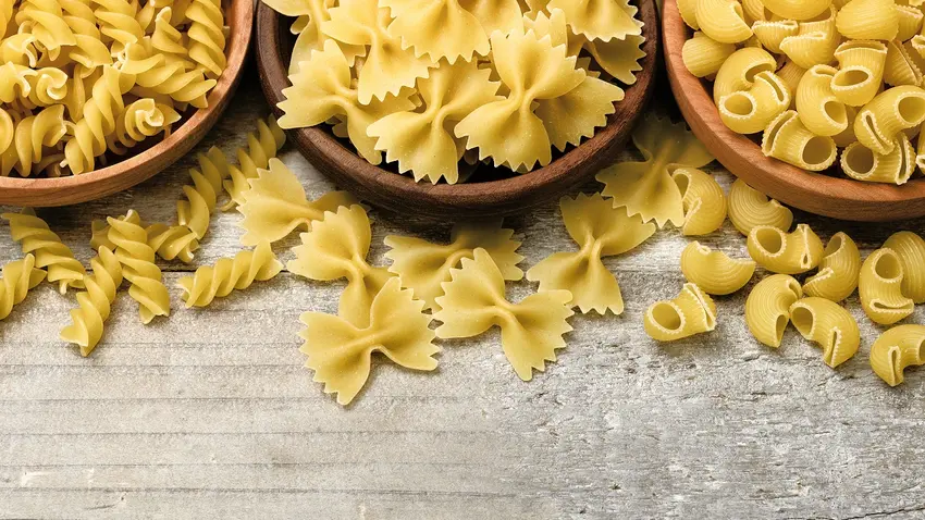 Bowls of rotini, farfalle and pippete dry pastas.