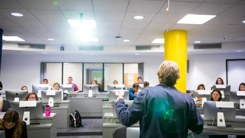 Professor teaching at front of classroom