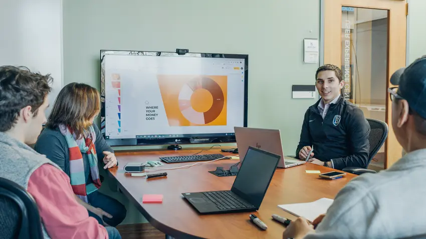 Small group of students from an MBA program near Boston working together in classroom.