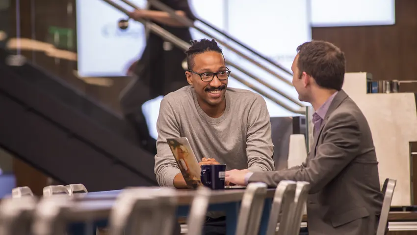 Two employees sitting at a conference table