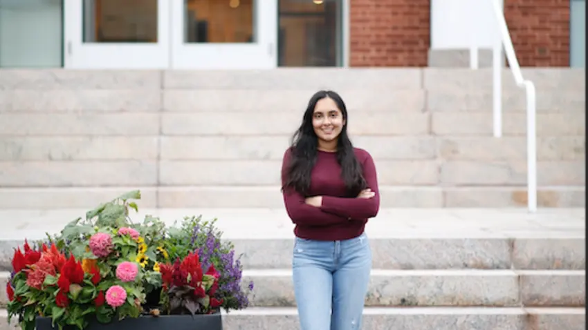 Sandhya Sangappa ’24 stands by steps on Bentley Campus
