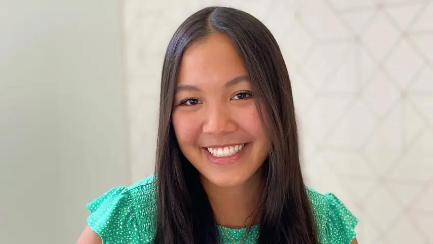 Banmai Huynh wearing a green blouse smiling