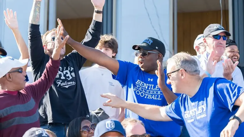 People cheering on Bentley in the stands