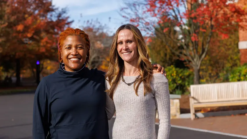 Author and activist Alison Mariella Désir poses with Lecturer in Marketing Erin Flynn outside of the Bentley Library.