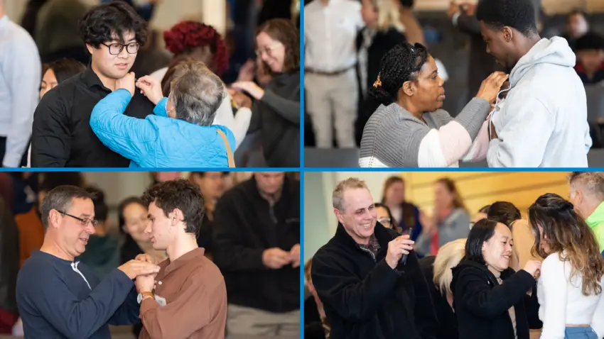 Bentley First-Gen students receiving pins from their families and friends