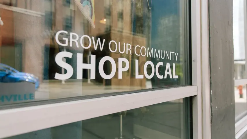 a storefront window that says shop local