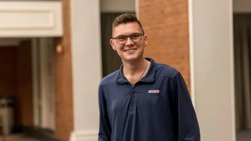 Andrew Fox wearing blue shirt and glasses