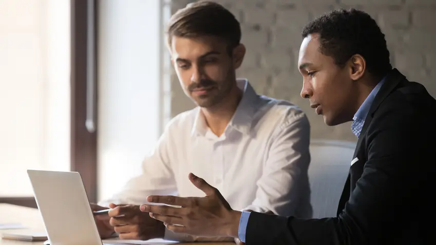 Entrepreneur and mentor reviewing a plan