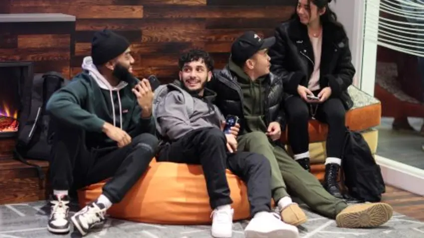 Bentley students sitting in bean bag chair in multicultural center lounge