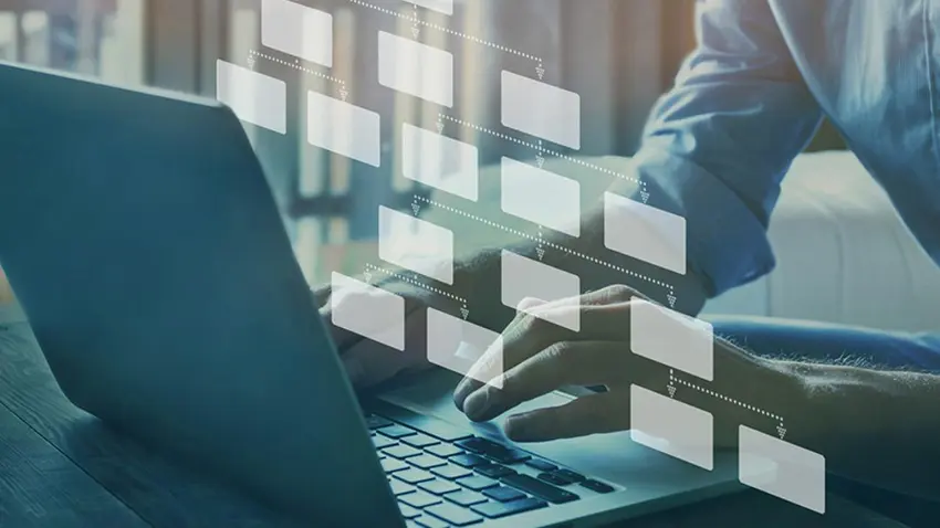 man typing on laptop with 3d icons