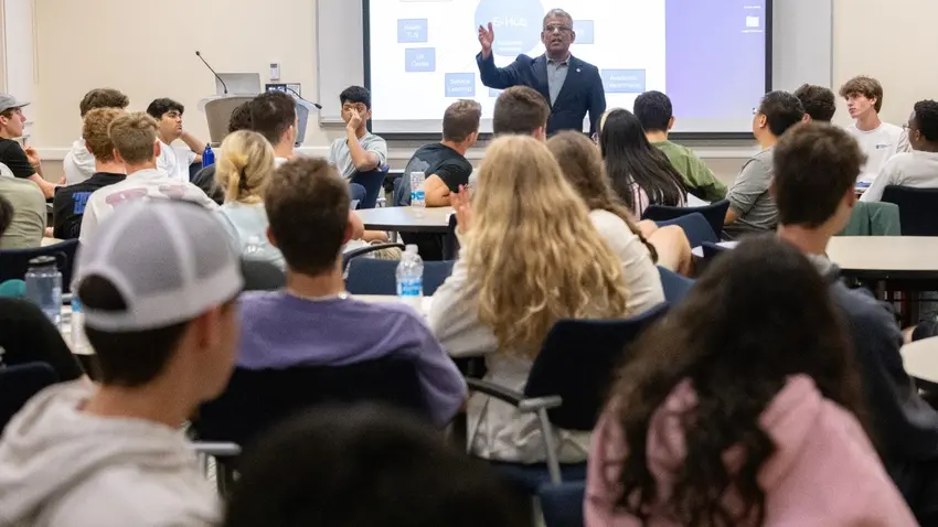 Trustee Professor Sandeep Purao speaks with students about the university's new E-Hub initiative during a meeting of the Bentley Entrepreneurship Society.