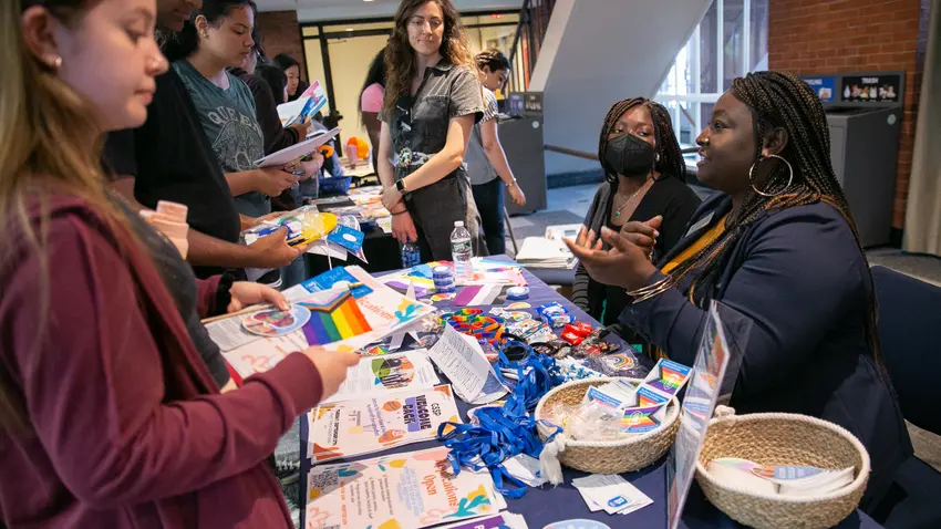 Nana Adu and Dominique Wilburn, co-advisers of the Rainbow Scholars program, chat with Bentley students.