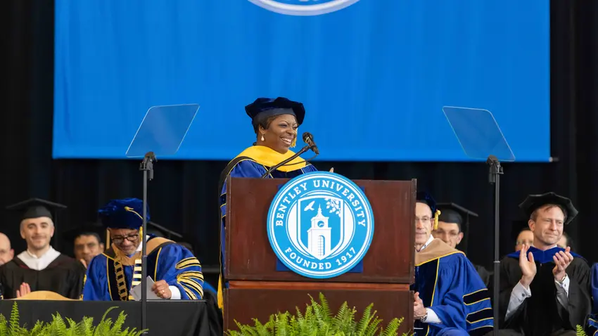 Karan Dyson delivers the keynote speech at the podium 
