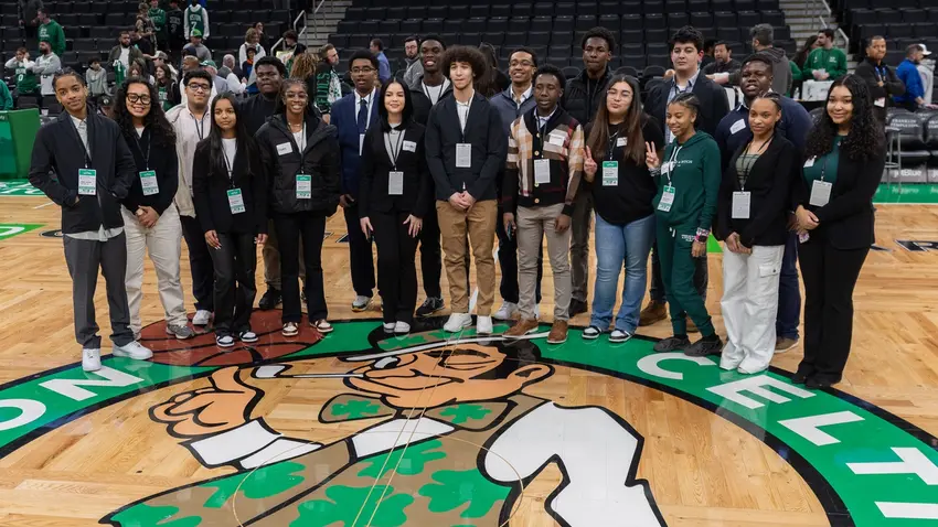 Participants in Celtics Career Day, presented by Bentley University, gather on the court at TD Garden.