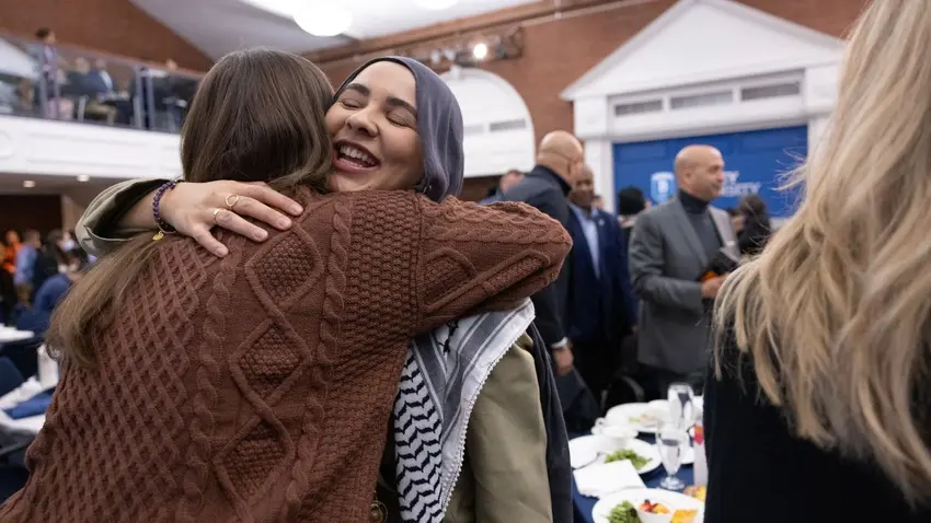 Attendees embracing during the Bentley University annual MLK social justice program