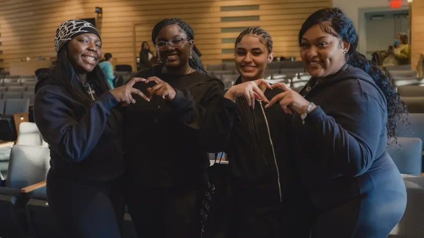 A group of performers pose after a talent show performance as part of the annual Bentley University MLK social justice program  