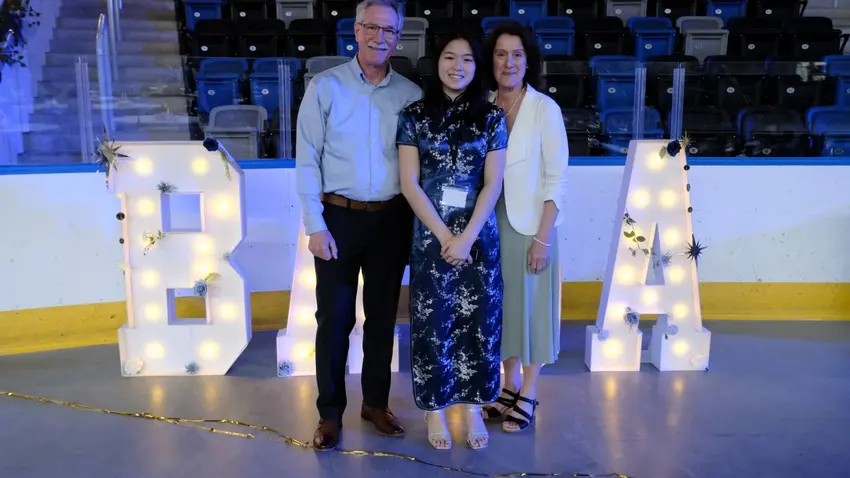 Attendees in front of a lighted "BASA" sign at the Asian Culture Gala, sponsored by the Bentley Asian Students' Association