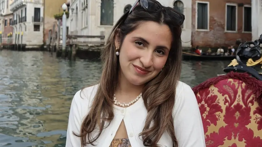Andrea Rodriguez, a woman with brown hair and a white cardigan