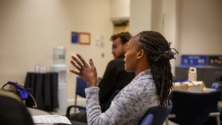 A student talking with expressive hands.