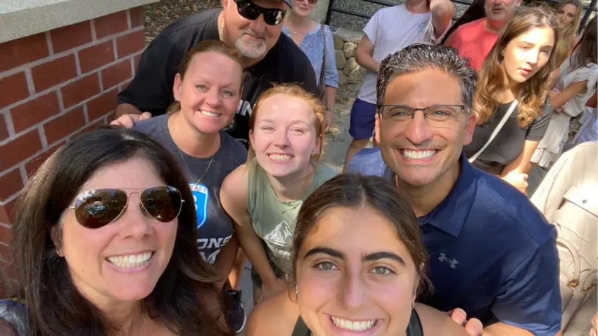 Ava Movsessian ’26 and her new Bentley roommate pose with their families on their first-year move-in day