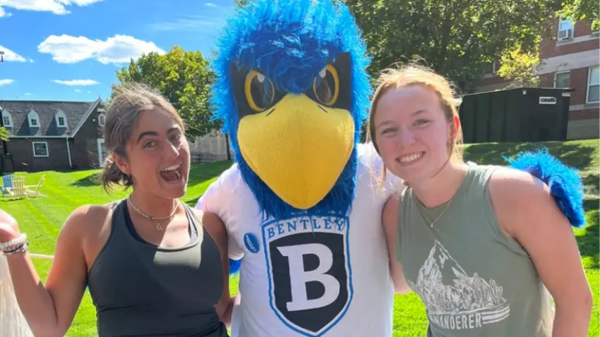 Ava Movsessian ’26 and her new Bentley roommate pose with Bentley mascot Flex the Falcon on her first-year move-in dayr Bentley move-in day