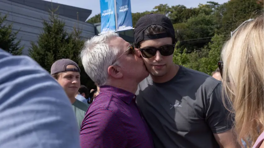 A family kisses their student during Bentley Class of 2029 move-in day