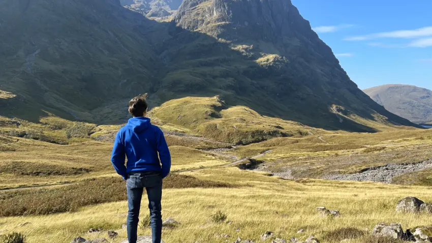 Man standing in front of mountain in Scotland
