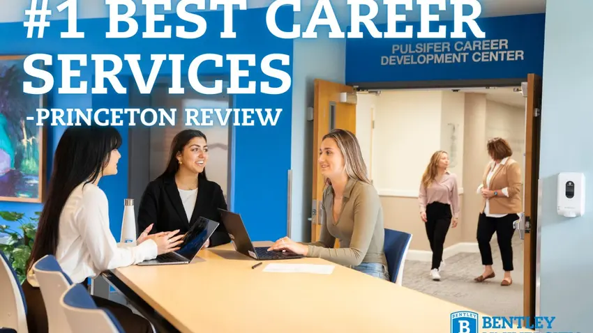 This is an image of female students sitting around a conference table.