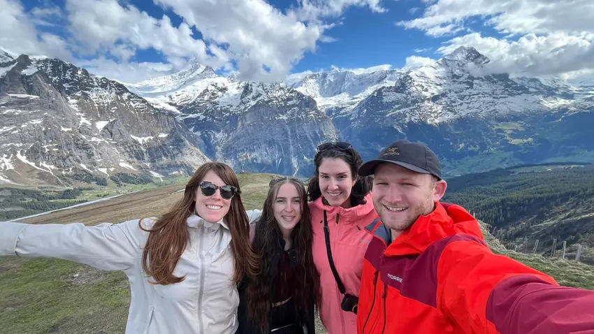Group of people standing in front of a mountain in Switzerland