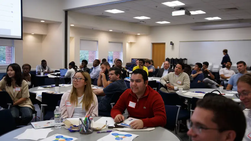 An audience of listening students.