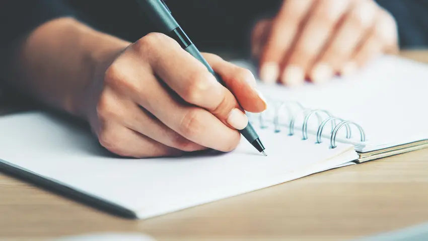 writing with pen on notebook