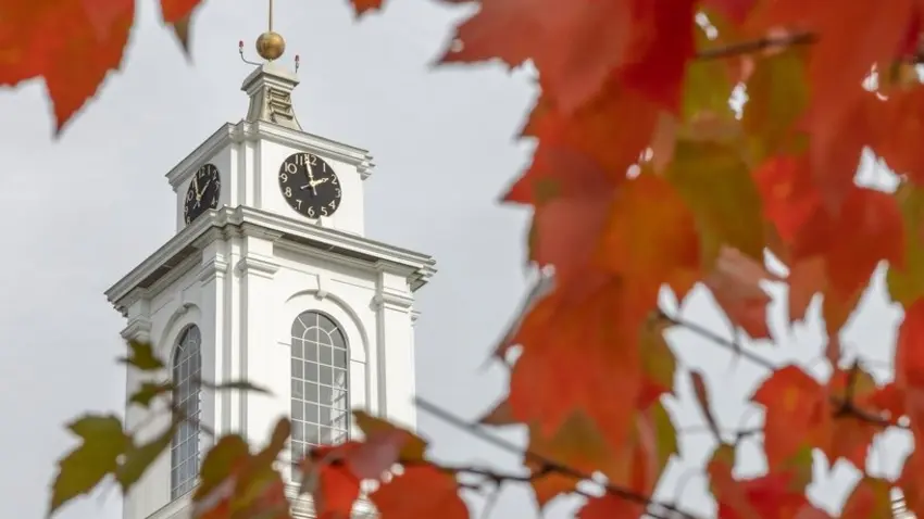 Clock tower amid red leaves in the fall