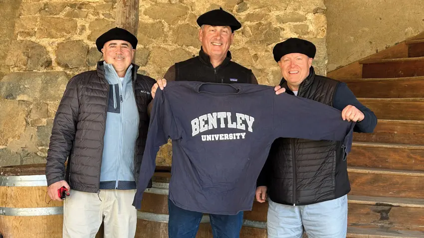 alumni and friends hold up a bentley sweatshirt