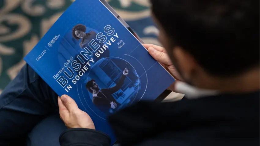 Attendee holding the Bentley-Gallup Business in Society survey during an event in Washington, DC