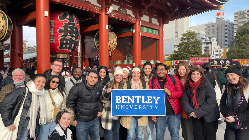 Group at a temple with a Bentley sign