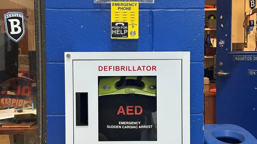 AED in Dana Center pool area near aquatics director office