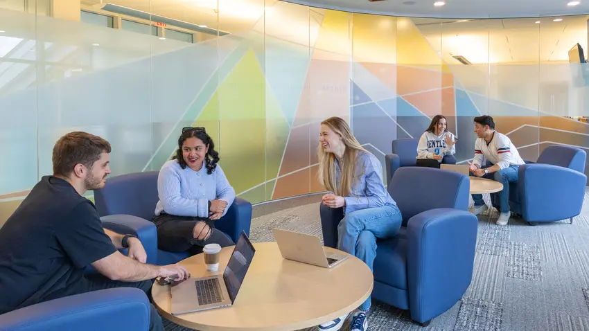 Bentley graduate students gather outside the graduate student lounge on campus