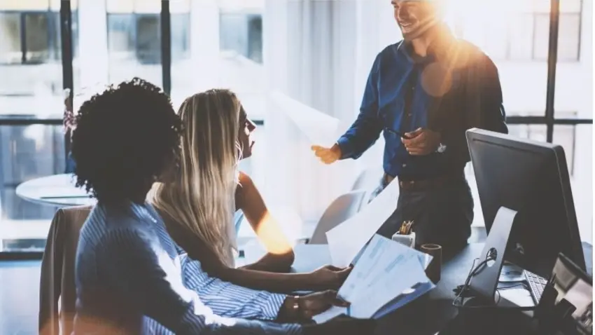 Co-workers conversing at a table