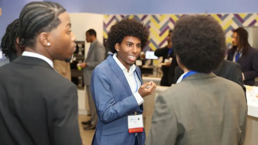 A Bentley student mingles during the Bentley Mankind Movement networking conference