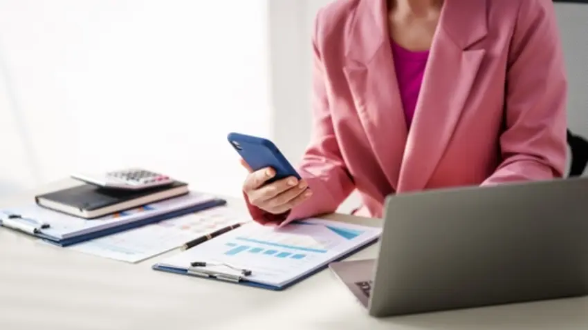 40-year-old middle-aged Asian businesswoman wearing pink suit, business finance, investment strategies, risk management.