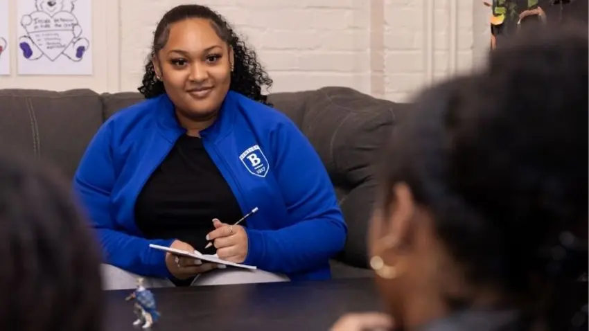Bentley student Aliyah Isaacs works with a local youth as part of Bentley Service-Learning and Civic Engagement Center