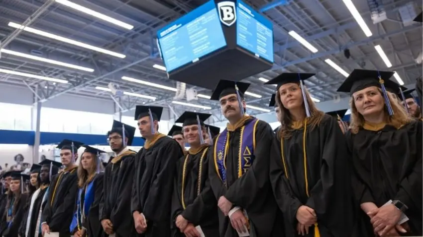 Graduates stand shoulder-to-shoulder during the McCallum Graduate School of Business 51st commencement ceremony. 