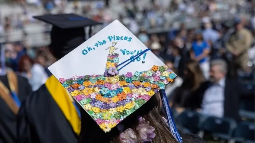 Bentley Class of 2026 graduate cap adorned with scene from the book "Oh the Places You'll Go"