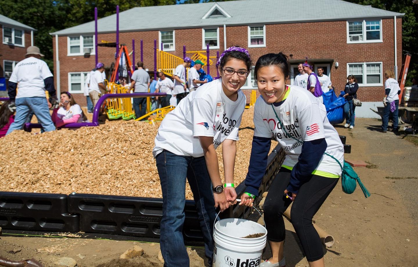 Two female students assist with service-learning project.